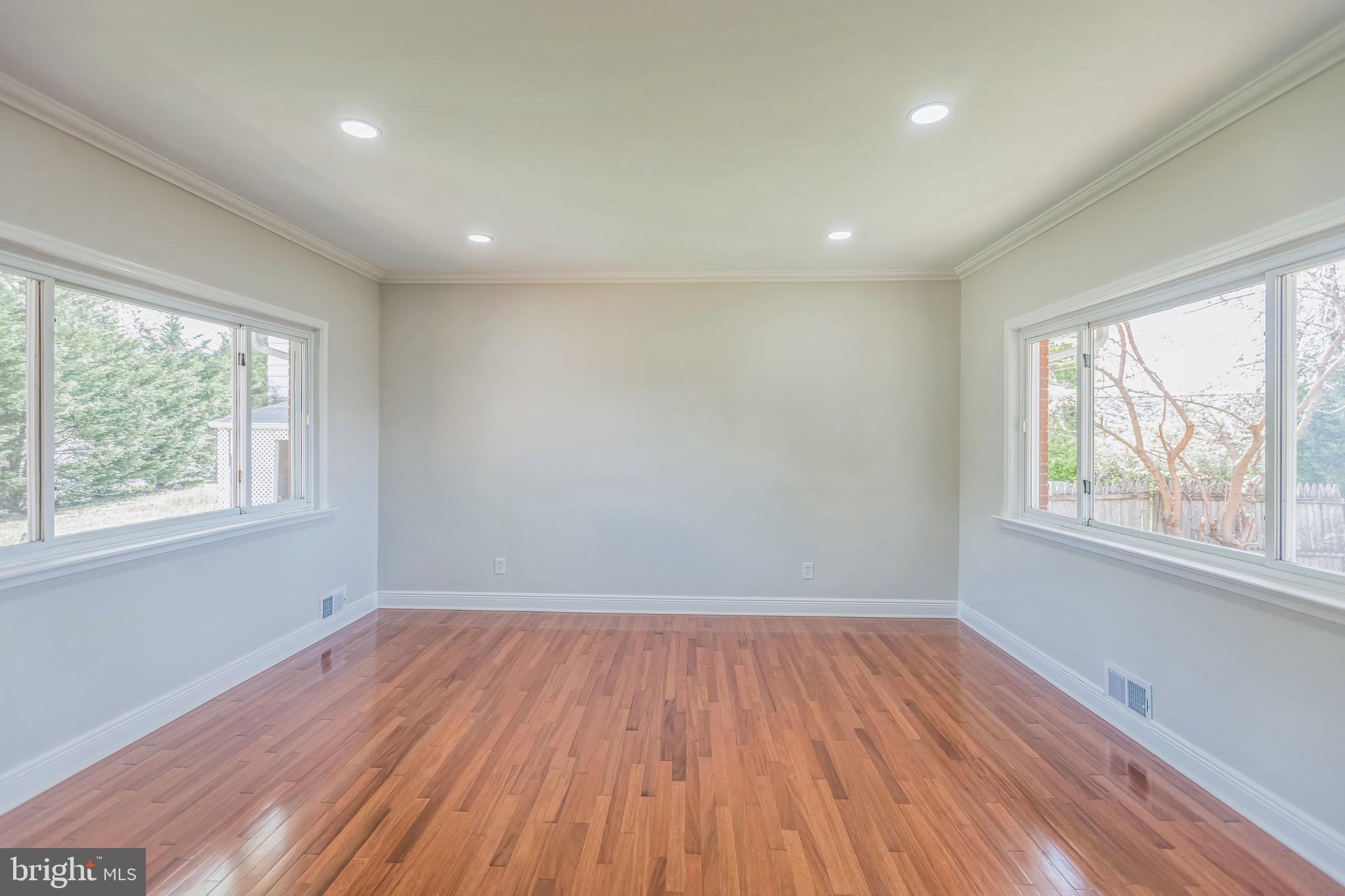 11308 Veirs Mill Road Silver Spring, MD 20902 - Photo 3 of 21 an empty room with wooden floor and windows