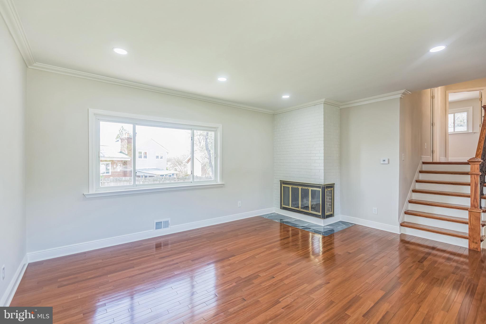 11308 Veirs Mill Road Silver Spring, MD 20902 - Photo 4 of 21 a view of an empty room with wooden floor and a window