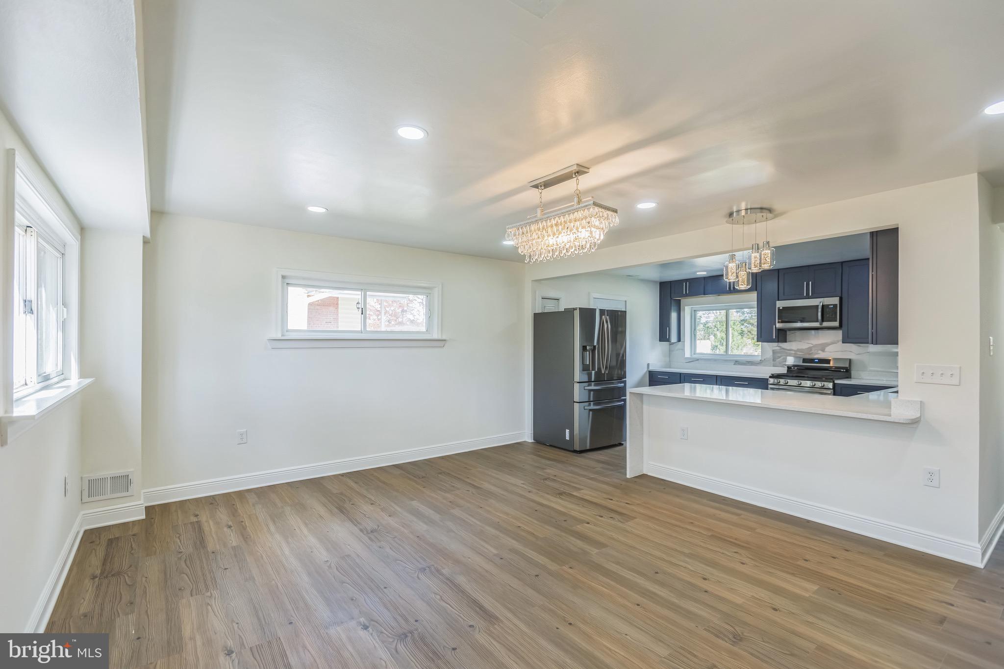 11308 Veirs Mill Road Silver Spring, MD 20902 - Photo 6 of 21 a view of a kitchen with a sink and a refrigerator