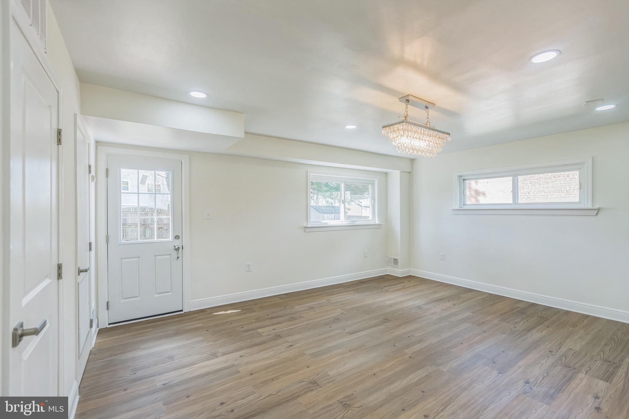 11308 Veirs Mill Road Silver Spring, MD 20902 - Photo 7 of 21 an empty room with wooden floor and windows