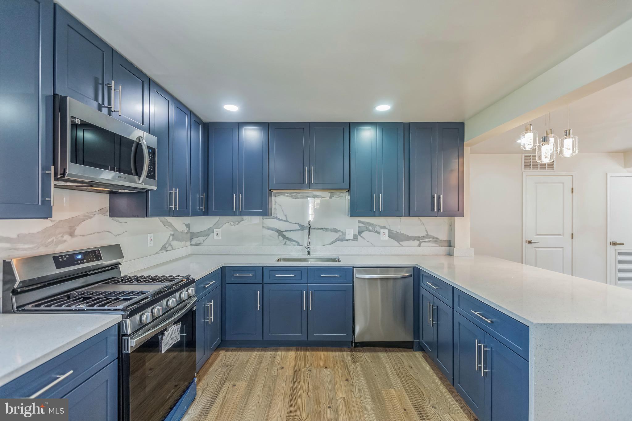 11308 Veirs Mill Road Silver Spring, MD 20902 - Photo 8 of 21 a kitchen with a sink stove and microwave