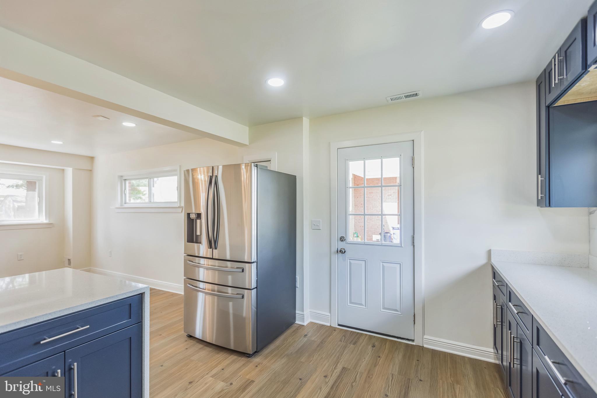 11308 Veirs Mill Road Silver Spring, MD 20902 - Photo 9 of 21 a kitchen with a refrigerator cabinet and wooden floor