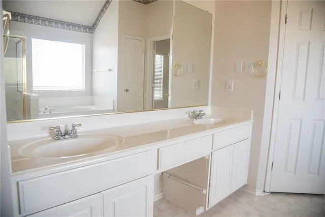 a bathroom with a double vanity sink and a mirror