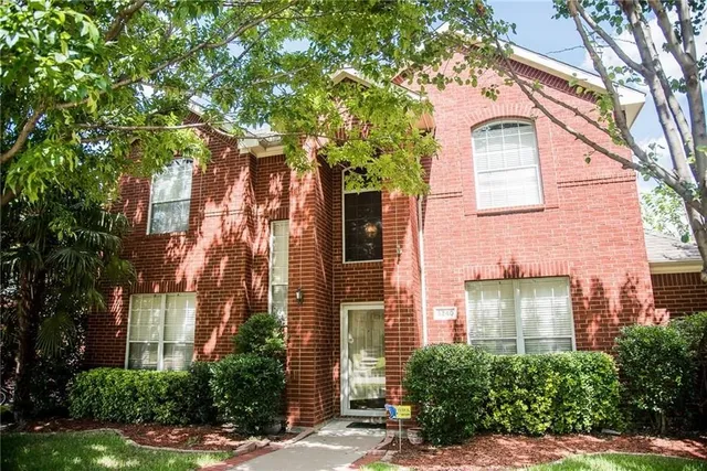 front view of a brick house with a large windows