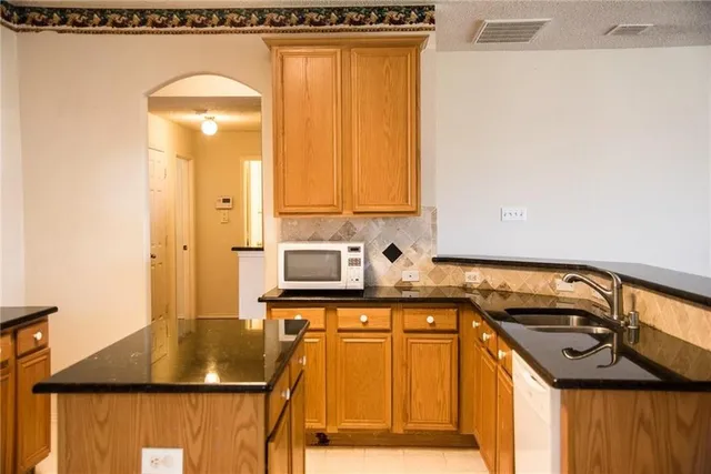 a kitchen with a stove a sink and a microwave