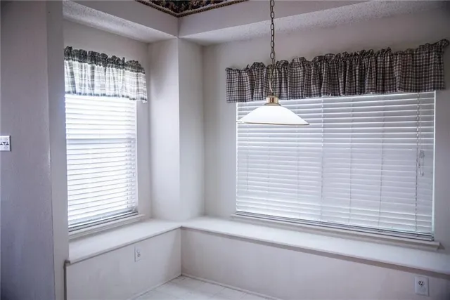 a view of a livingroom with a window and chandelier