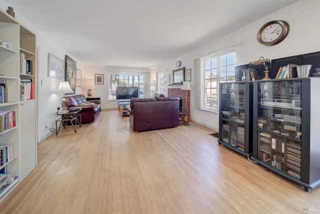 a living room with furniture large window and a fireplace