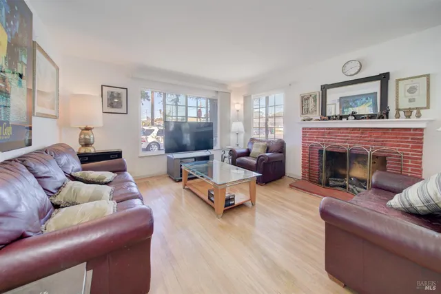 a living room with furniture large window and a fireplace