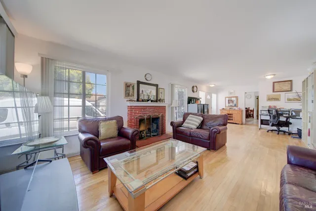 a living room with furniture fireplace and a window