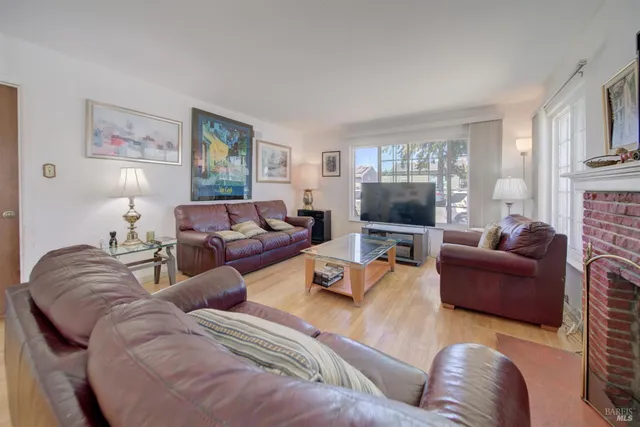 a kitchen with stainless steel appliances granite countertop a table chairs sink and cabinets