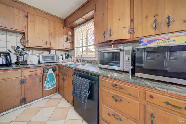 a kitchen with granite countertop cabinets and a wooden floor