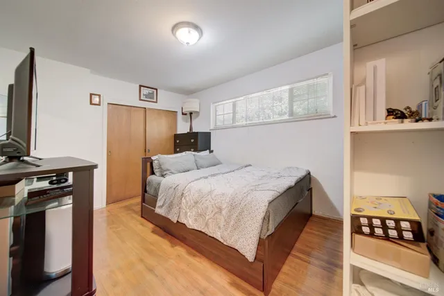 a bedroom with a bed and a cabinet