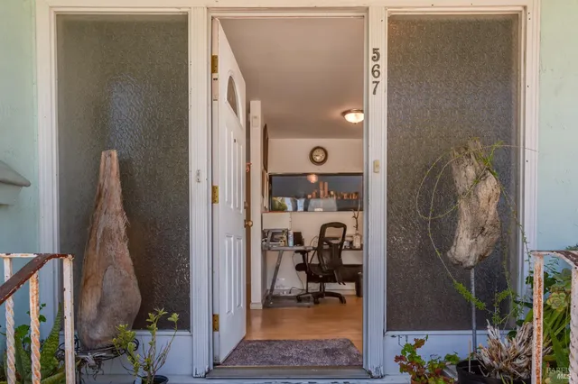 a view of a livingroom with workspace and a couch