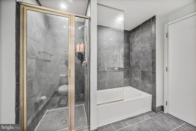a bathroom with a bathtub and a shower
