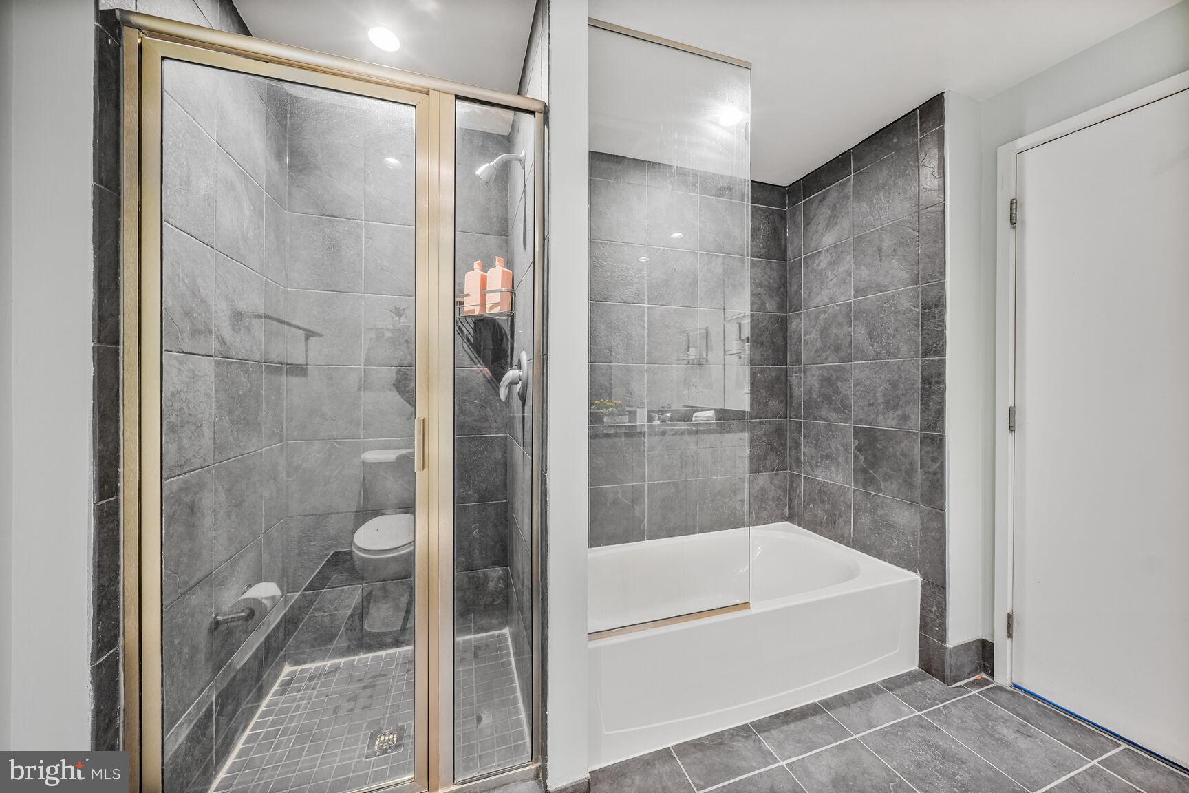 3409 Wilson Boulevard, Unit 211 Arlington, VA 22201 - Photo 12 of 30 a bathroom with a bathtub and a shower