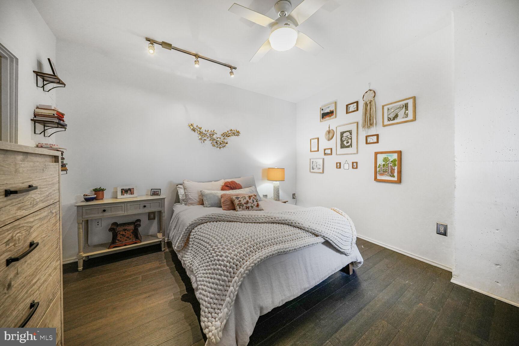 3409 Wilson Boulevard, Unit 211 Arlington, VA 22201 - Photo 14 of 30 a bedroom with a bed and a chandelier