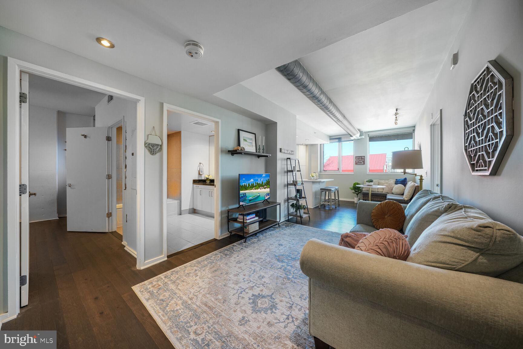 3409 Wilson Boulevard, Unit 211 Arlington, VA 22201 - Photo 2 of 30 a living room with furniture and a flat screen tv