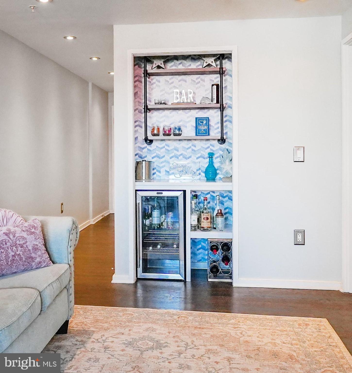 3409 Wilson Boulevard, Unit 211 Arlington, VA 22201 - Photo 4 of 30 a living room with furniture and a wooden floor