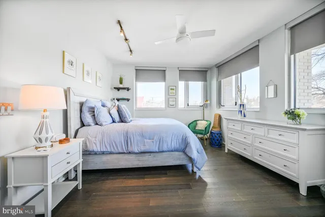 a bedroom with a bed and windows