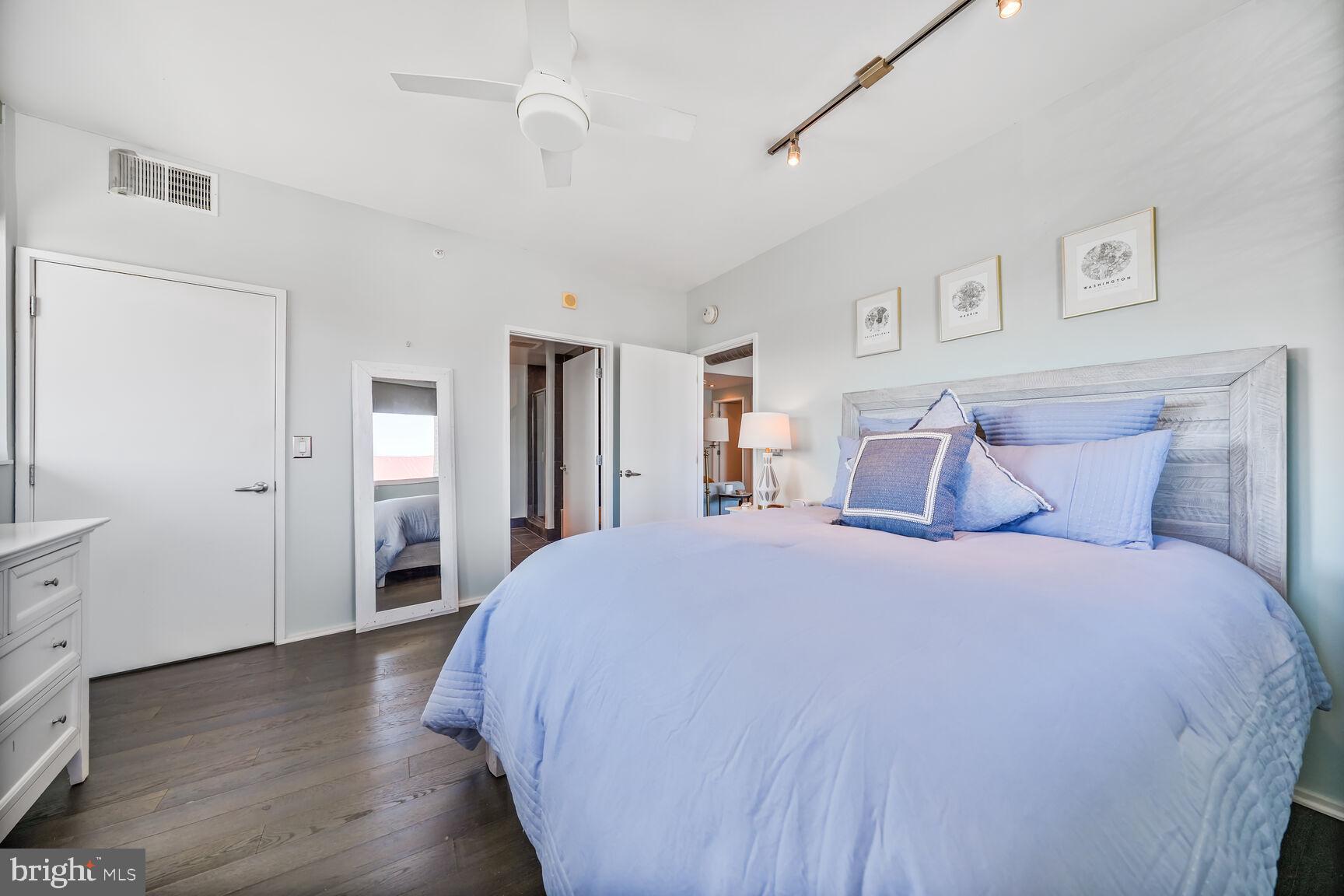 3409 Wilson Boulevard, Unit 211 Arlington, VA 22201 - Photo 10 of 30 a spacious bedroom with a bed and wooden floor