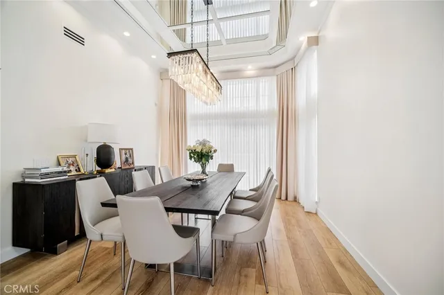 a kitchen with stainless steel appliances a refrigerator a stove a sink dishwasher and a refrigerator with wooden floor