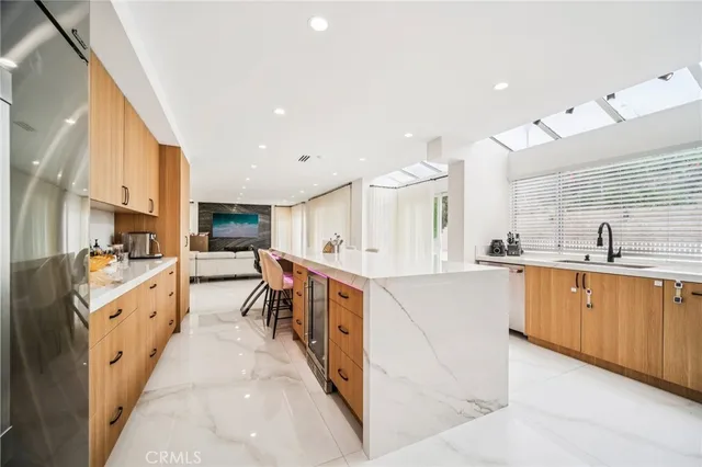 a kitchen with stainless steel appliances granite countertop a sink and a window