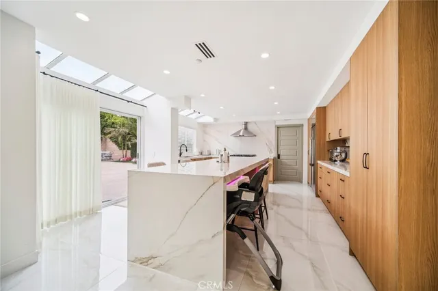 a bathroom with a mirror a sink and glass door