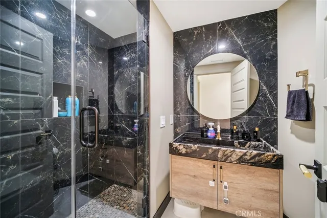 a bedroom with a bed and a view of en suite bathroom