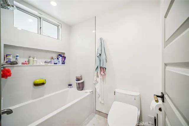a view of a balcony with wooden floor and fence