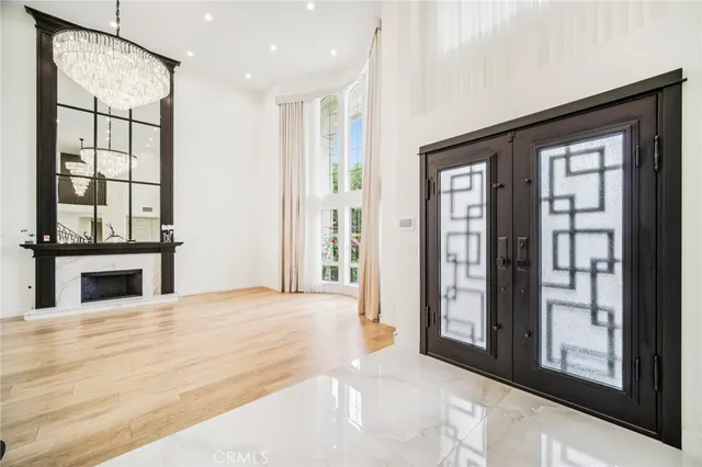 a view of an empty room with glass door and a window