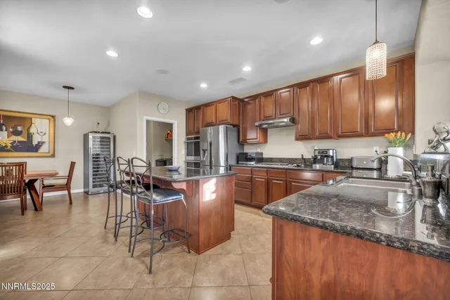 a kitchen with granite countertop sink cabinets and stainless steel appliances