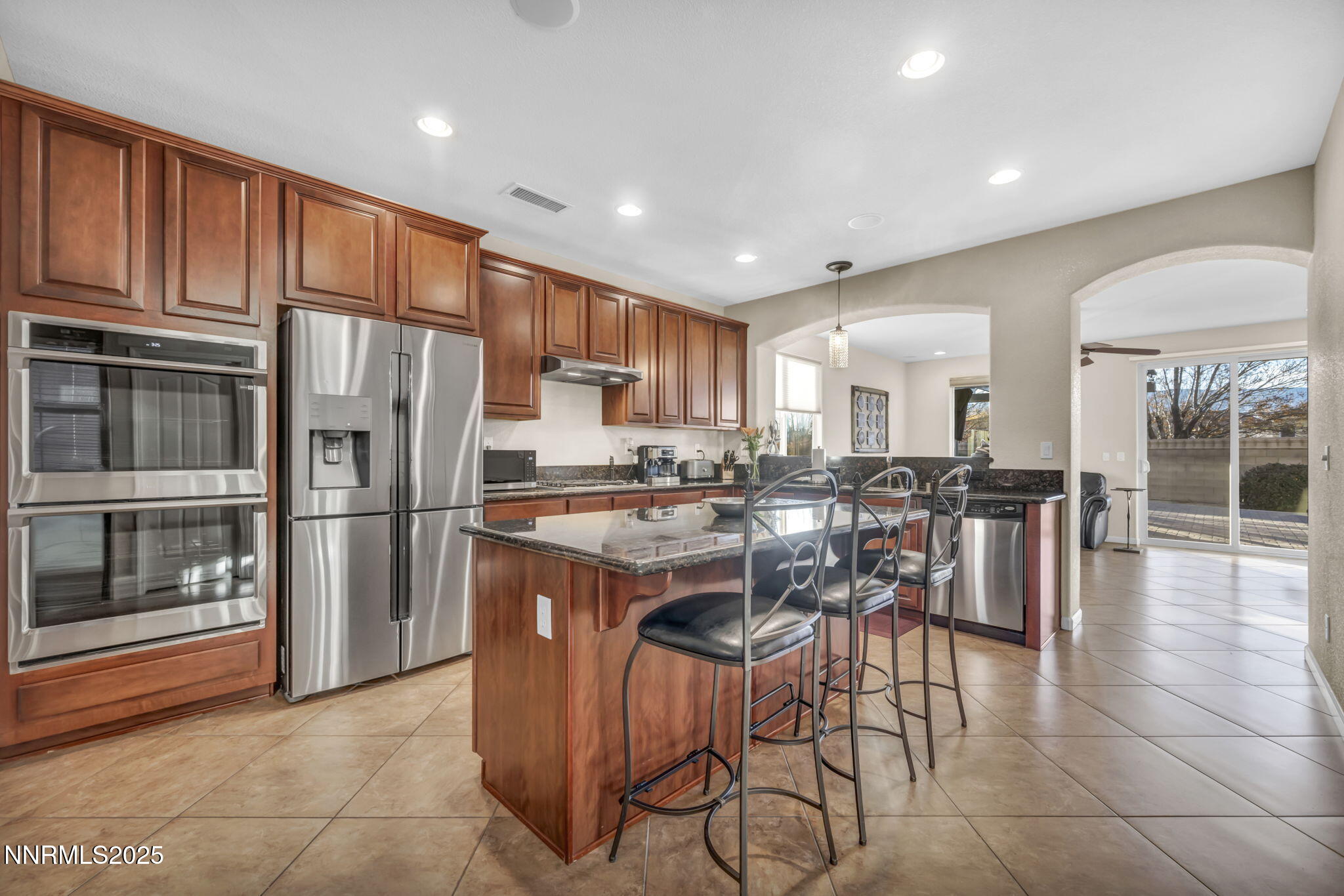11375 Messina Court Reno, NV 89521 - Photo 12 of 52 a kitchen with stainless steel appliances granite countertop a refrigerator and a stove top oven