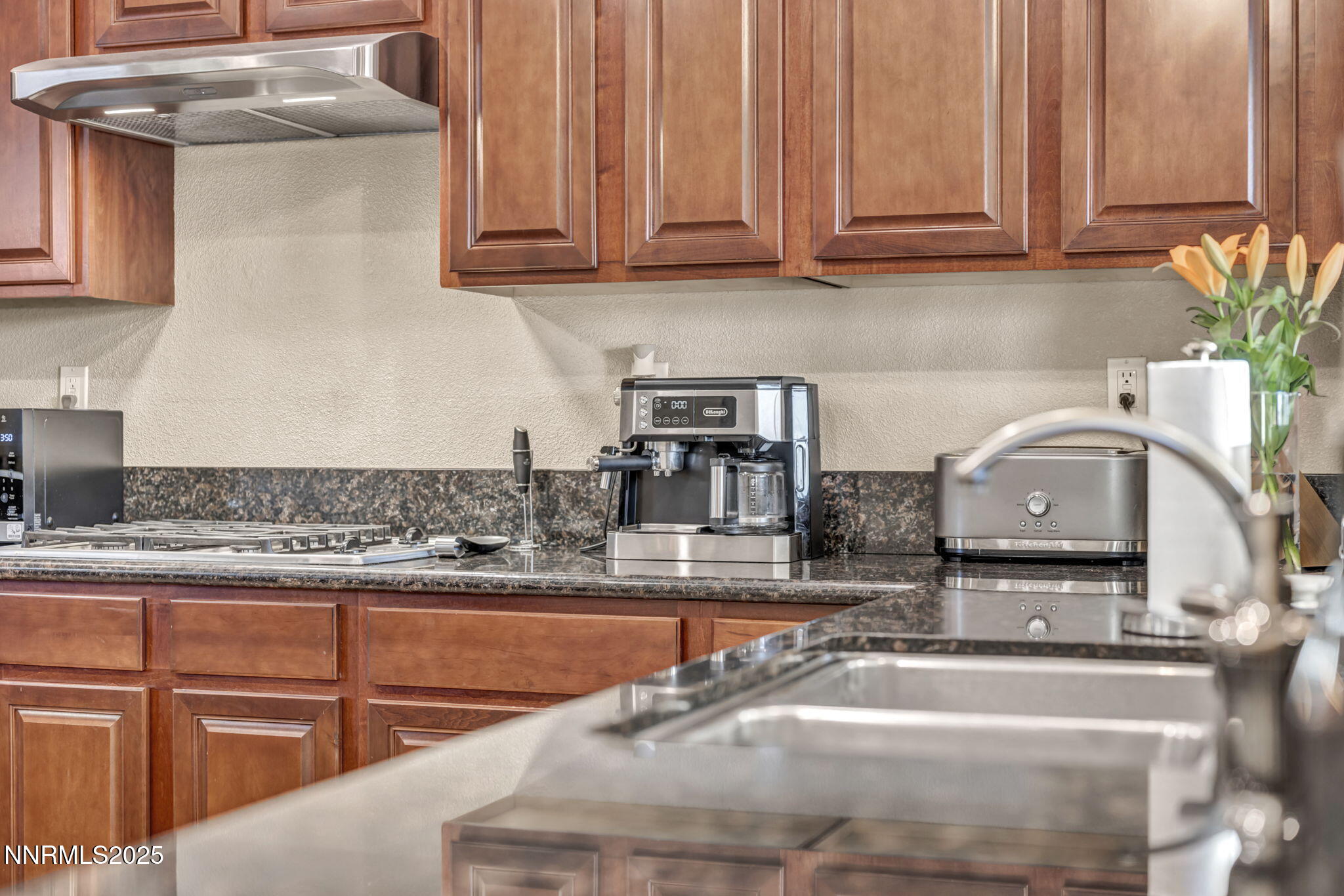 11375 Messina Court Reno, NV 89521 - Photo 15 of 52 a kitchen with granite countertop a sink and a stove