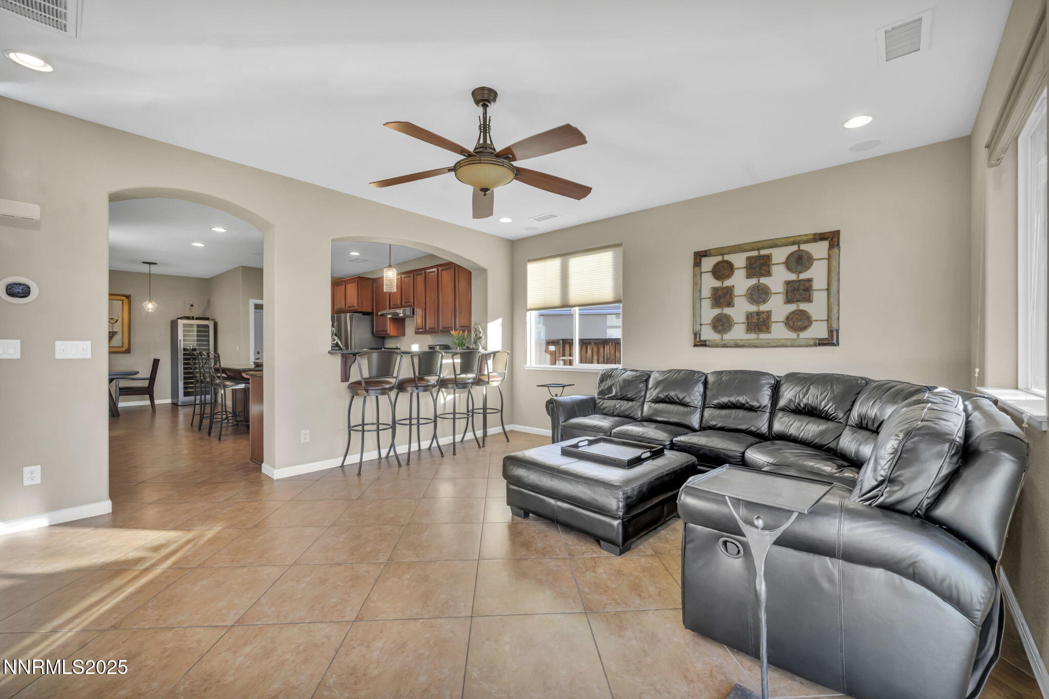 11375 Messina Court Reno, NV 89521 - Photo 17 of 52 a living room with couches a coffee table and kitchen view with wooden floor