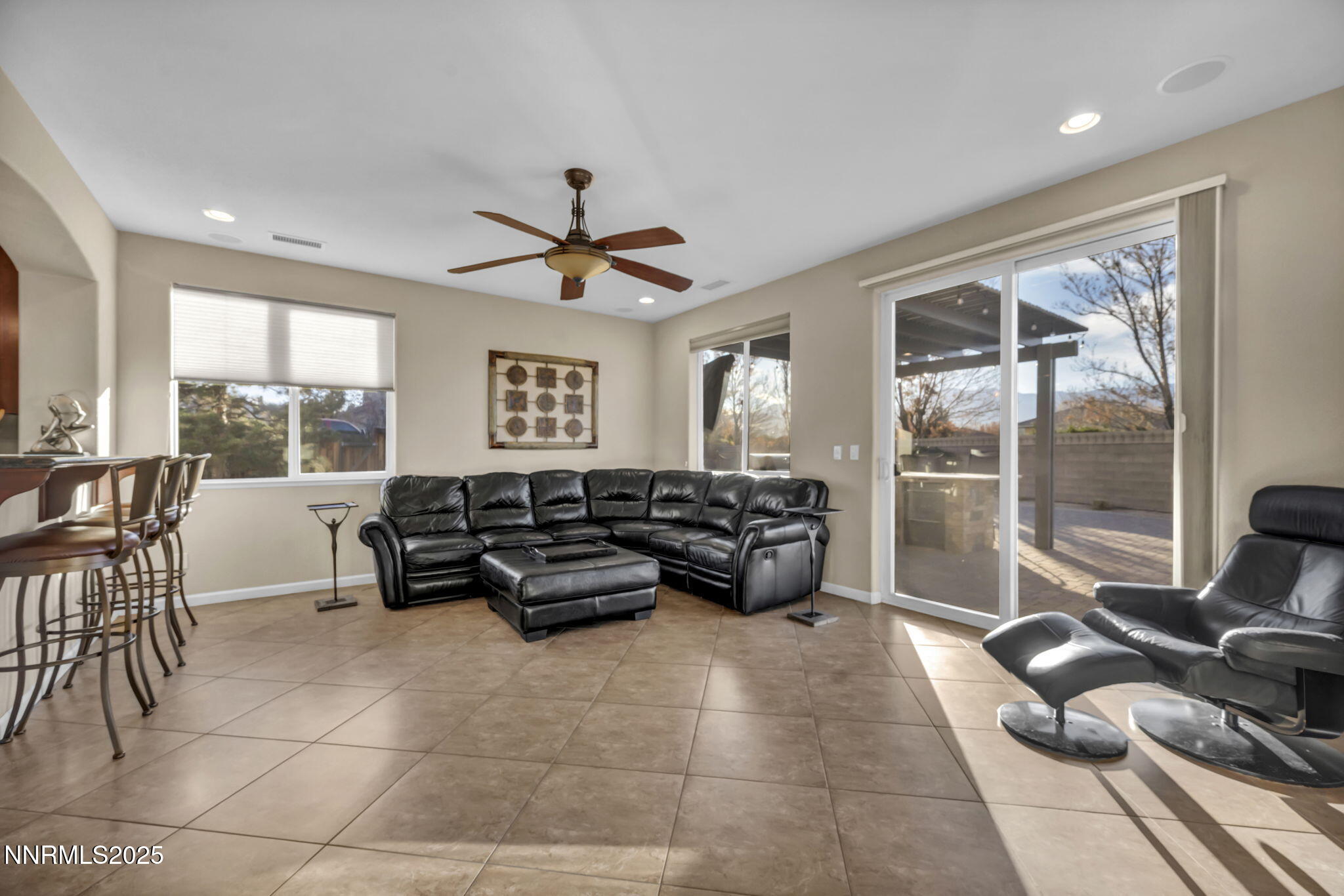 11375 Messina Court Reno, NV 89521 - Photo 18 of 52 a living room with furniture and a floor to ceiling window