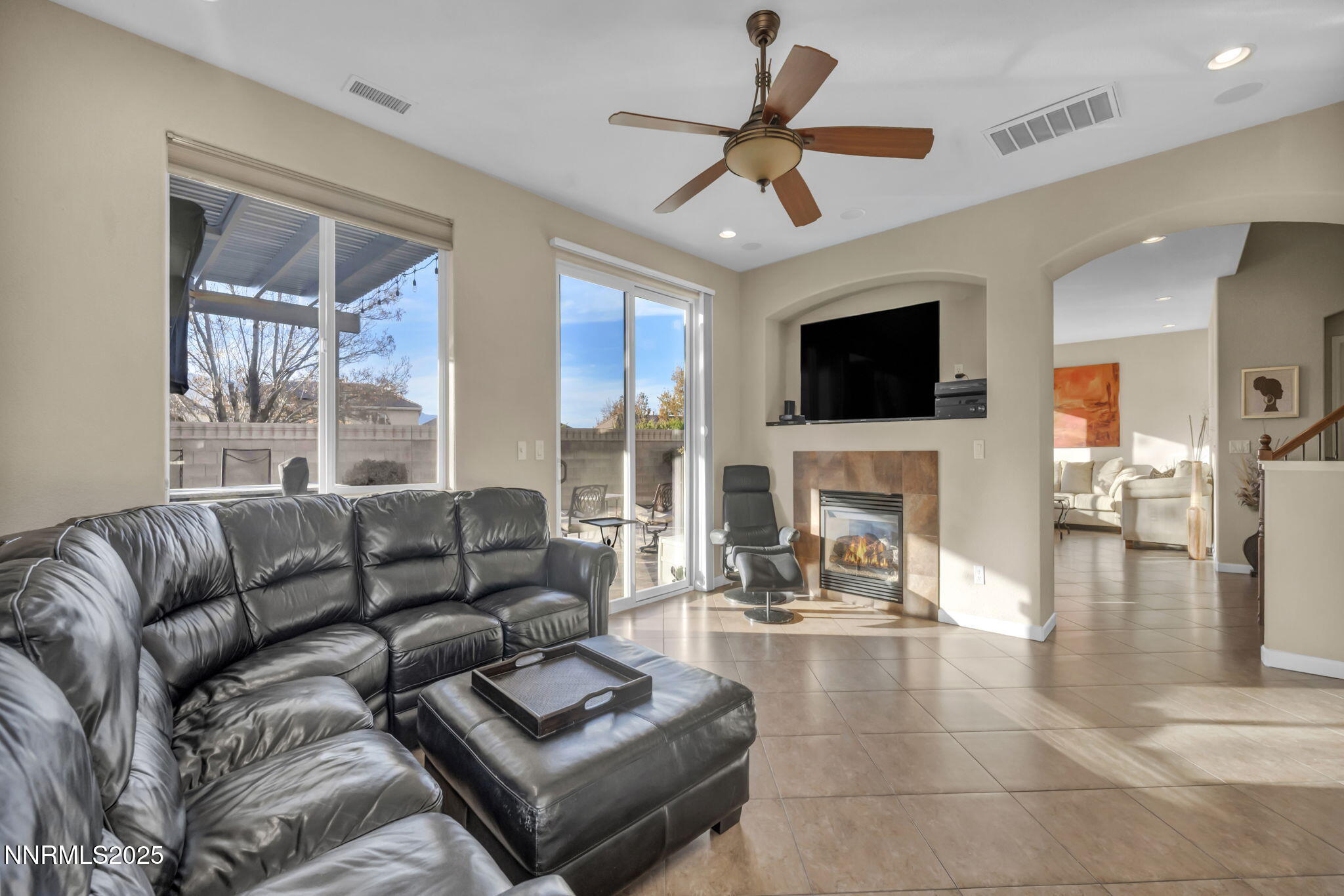 11375 Messina Court Reno, NV 89521 - Photo 19 of 52 a living room with furniture a fireplace and a flat screen tv