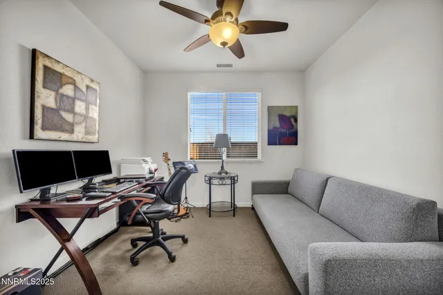 a workspace with a couch and a window