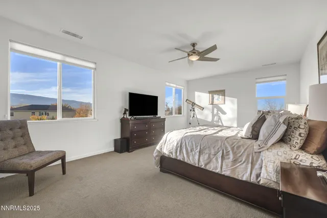 a living room with a bed and a flat screen tv
