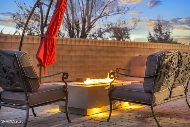 a view of backyard with outdoor seating and trees
