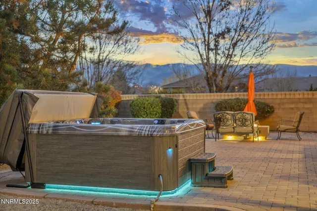 a view of a swimming pool with a table and chairs