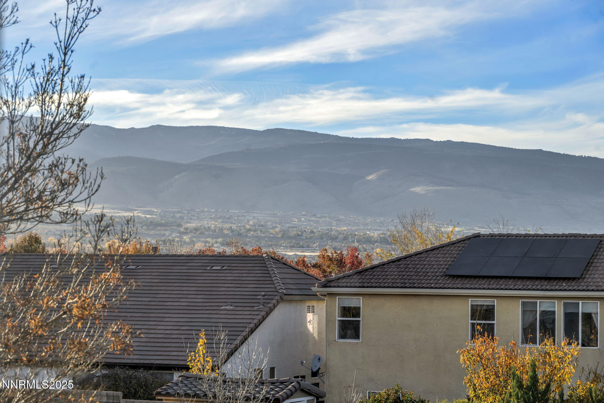 11375 Messina Court Reno, NV 89521 - Photo 51 of 52 a view of a house with a yard and table and chairs under an umbrella