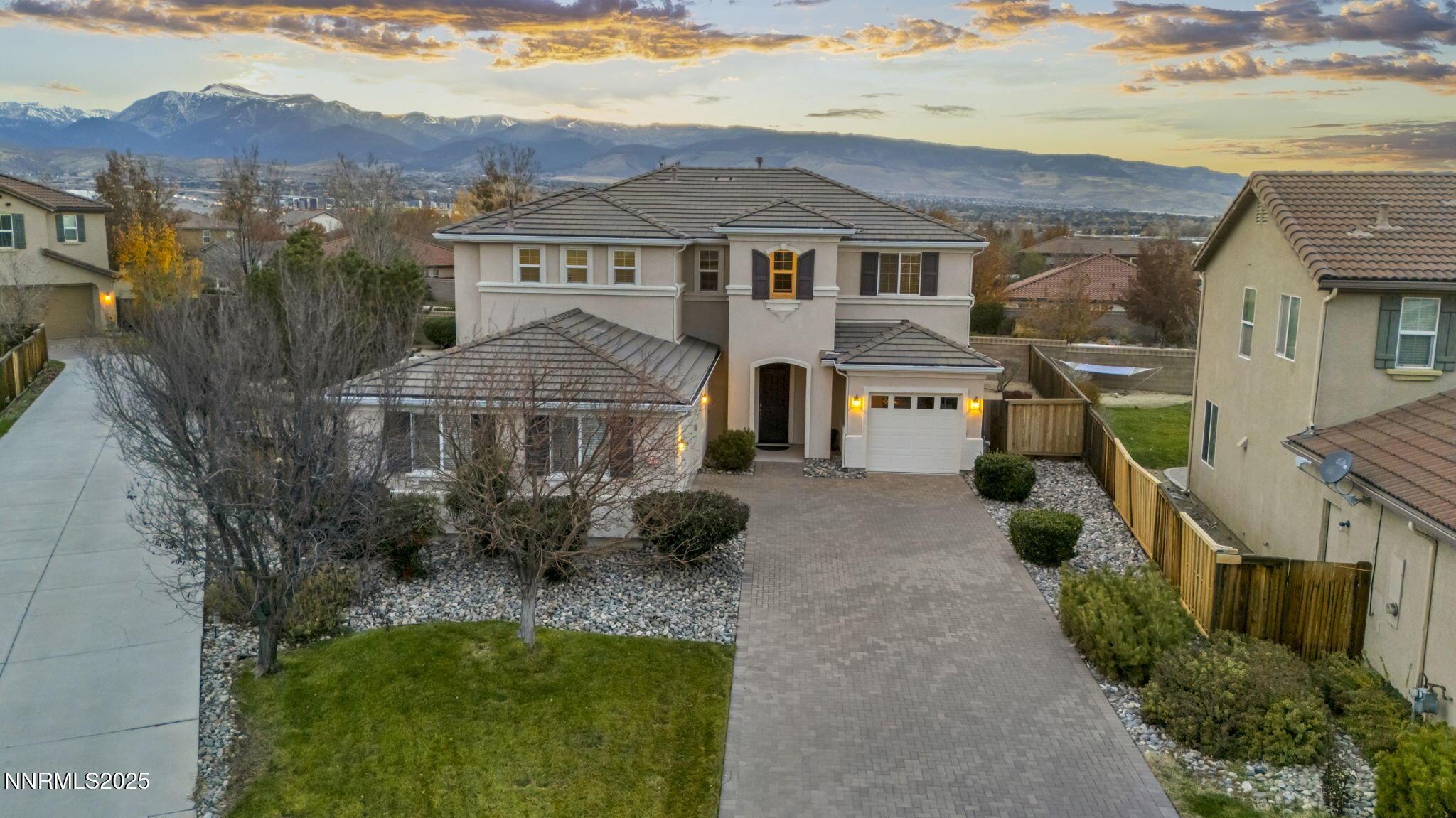 11375 Messina Court Reno, NV 89521 - Photo 6 of 52 a view of a white house next to a yard with potted plants