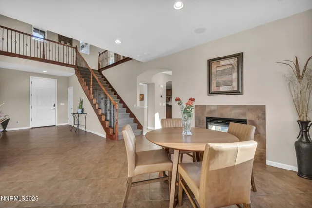 a view of a dining room with furniture wooden floor and a fireplace