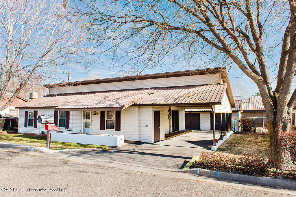 554 Jarrad Avenue Rifle, CO 81650 - Photo 1 of 21 a view of a house with a large windows and a large tree