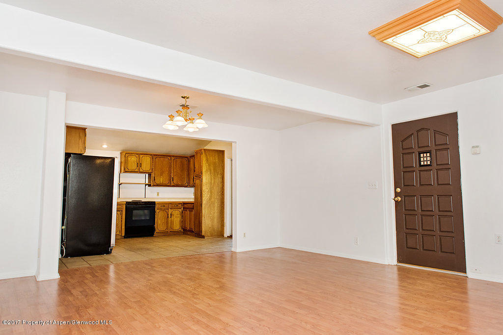 554 Jarrad Avenue Rifle, CO 81650 - Photo 3 of 21 a view of an empty room with a kitchen and a window