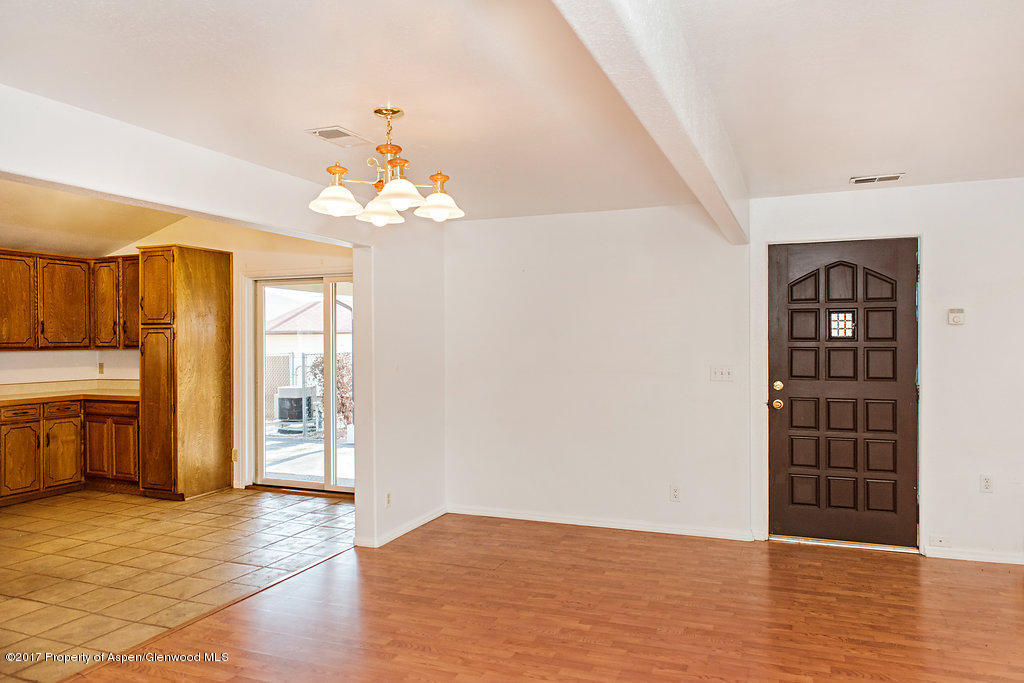 554 Jarrad Avenue Rifle, CO 81650 - Photo 4 of 21 wooden floor in an empty room with a window