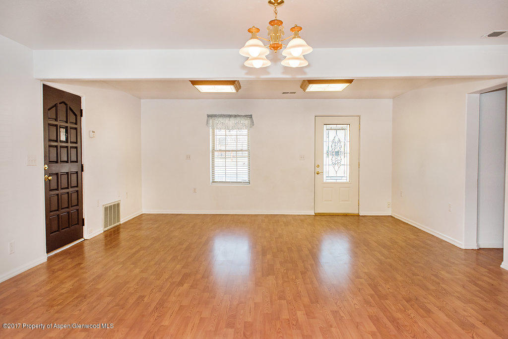 554 Jarrad Avenue Rifle, CO 81650 - Photo 6 of 21 wooden floor in an empty room with a window