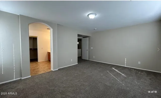 an empty room with a bathroom and a sink