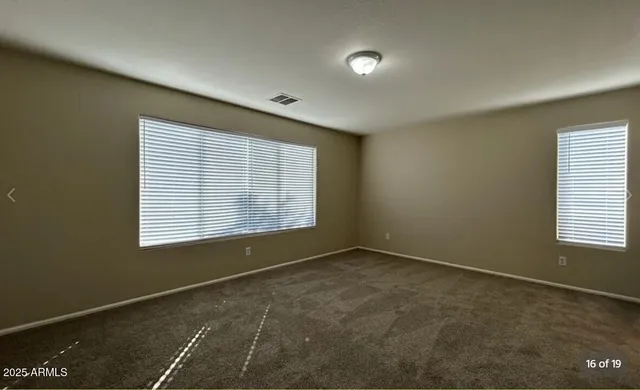 an empty room with a empty space and windows