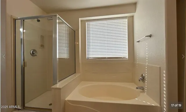 a bathroom with a bathtub and a shower